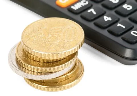 Calculator with stack of coins Foto stock