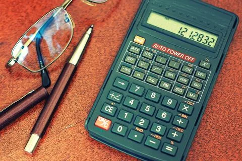 Calculator table glasses Stock Photos
