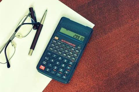 Calculator table glasses Stock Photos
