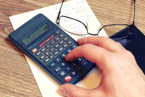 Calculator table glasses Stock Photos