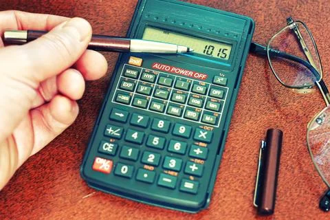 Calculator table glasses Stock Photos