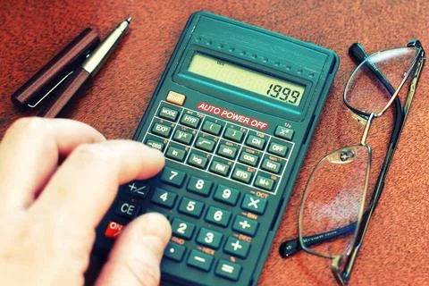 Calculator table glasses Stock Photos
