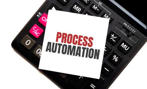 Calculator with text PROCESS AUTOMATION with white paper Stockfoto's