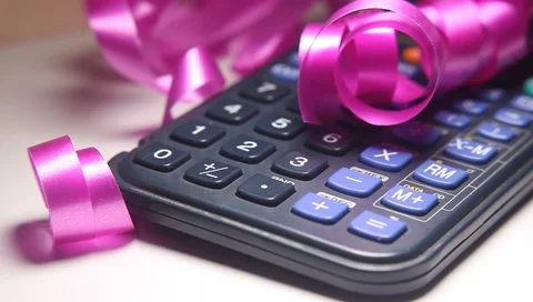 Calculators computing device and festive color ribbon, concept of spending mo Vídeo Stock 99014829
