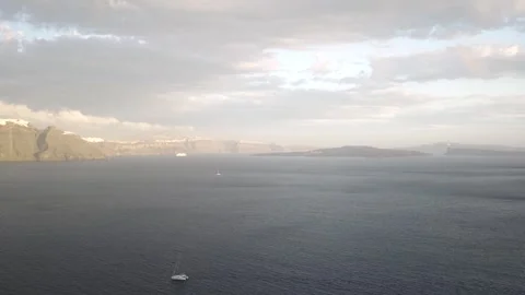 Caldera sunset while a sailboat crosses the archipelago Stock Footage 257673016