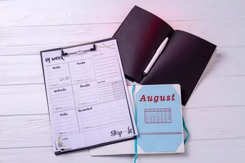 Caledars with week and august month on white desk. Stock Photos