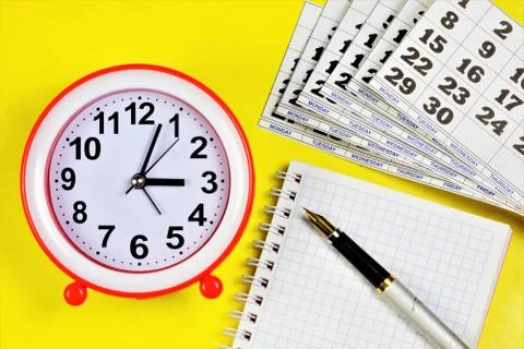 Calendar, clock, and Notepad for planning business goals Stock Photos