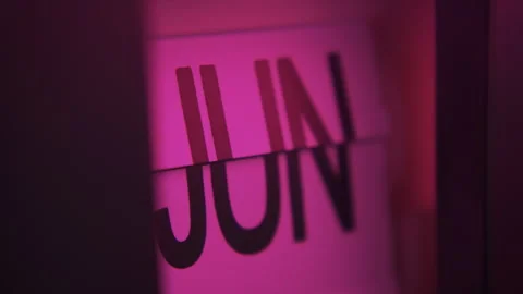 A calendar clock in pink light changing the months from January to December Stock Footage 287453064