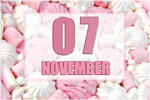 Calendar date on the background of white and pink marshmallows.  November 7 i Stock Photos