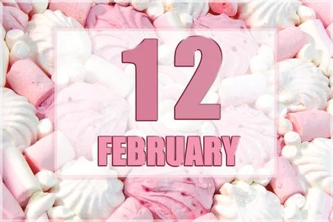 Calendar date on the background of white and pink marshmallows. February 12 i Stock Photos