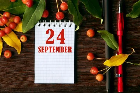 Calendar date on wooden dark desktop background with autumn leaves and small  Stock Photos