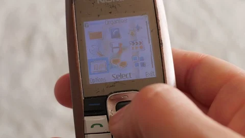 Calendar on outmoded, old school model of  mobile phone Stock Footage 87184523