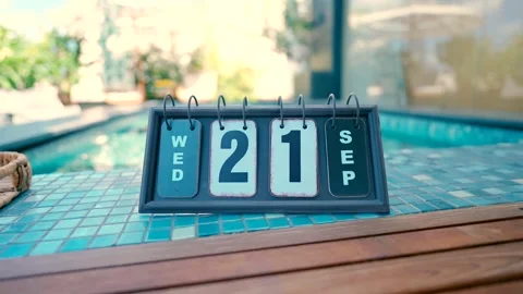 A calendar stands on the edge of the pool with the date September 21st. Stock Footage 240134505