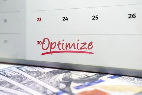 Calendar with the word Optimize handwritten in red ink over US hundred doll.. Stock Photos
