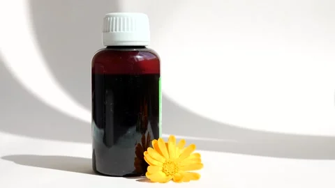 Calendula oil bottle on a white background with copy space. Essential oil . Stock Footage 302286834