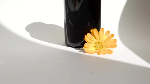 Calendula oil bottle on a white background with copy space. Essential oil . Stock Footage 302286867