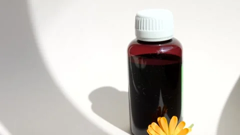 Calendula oil bottle on a white background with copy space. Essential oil . Stock Footage 302286952