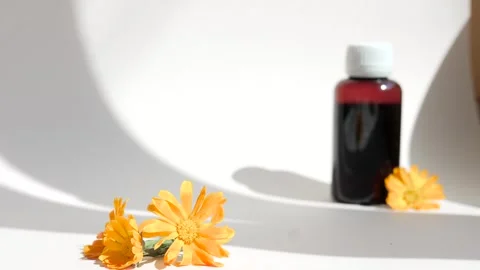 Calendula oil bottle on a white background with copy space. Essential oil . Stock Footage 302286974
