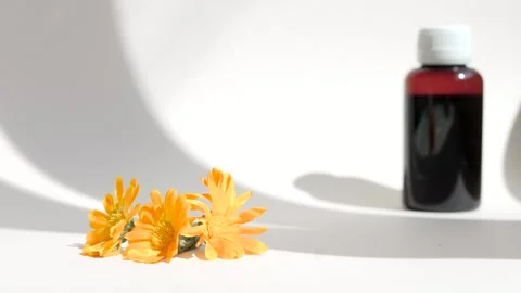 Calendula oil bottle on a white background with copy space. Essential oil . Stock Footage 302287010