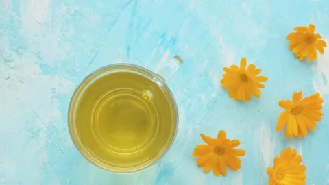 Calendula tisane in glass mug Stock Footage 136933902