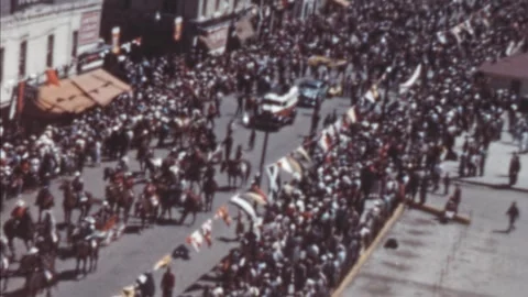 Calgary - 1948: Float pulled by horses advances on the street at Stampede Parade Stock Footage 290070921