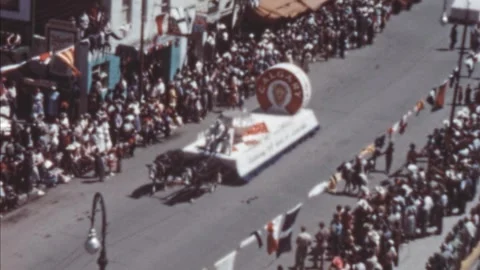 Calgary - 1948: Stampede Parade float makes its way down a crowded street Stock Footage 290070876