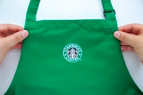 Calgary, Alberta, Canada. Aug 1, 2020. An Starbucks employee holding a store  Stock Photos