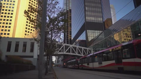 Calgary CTrain Light Rail Transit and Plus 15 Skyway Sunset View Stock-Footage 347409824
