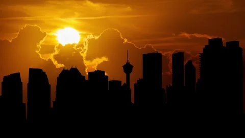 Calgary Skyline at Sunset, Time Lapse with Red  Sun and dramatic cloudy sky Stock Footage 278023684