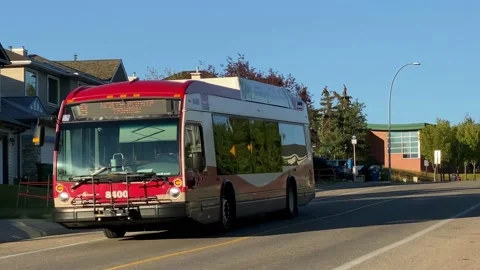 A Calgary transit bus driving by Hidden Valley a neighborhood in the north west Stock Footage 211786496