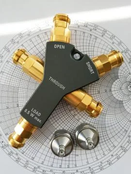 Calibration kit for RF VNA in front of Smith chart Stock Photos