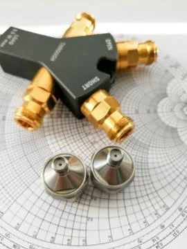 Calibration kit for RF VNA in front of Smith chart Stock Photos