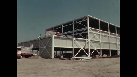 CALIFORNIA - 1963 - Construction workers hoisting metal sheets up a building Video stock 323262599