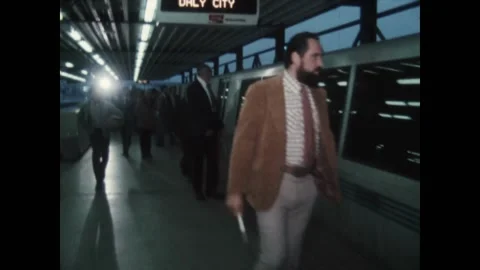 CALIFORNIA - 1972 - Commuters wait for, board, and disembark from BART (Bay Area Stock Footage 317607716
