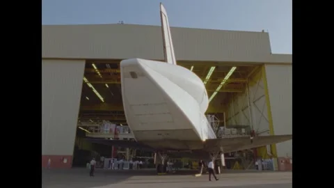 CALIFORNIA - 1985 - The Space Shuttle Atlantis is towed into a hangar at a NASA Stock Footage 341516133
