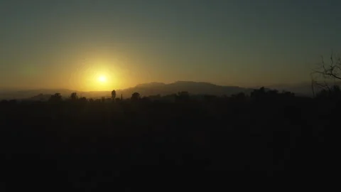 California Sunset behind mountain range with mountain silhoutte Stock Footage 340391927