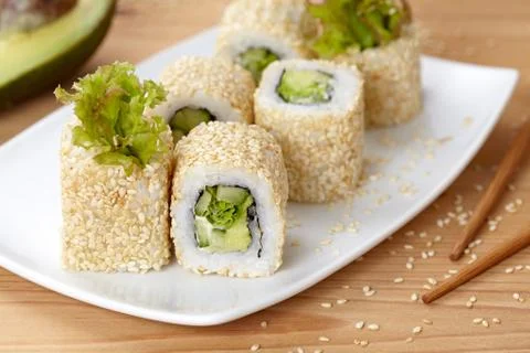 California vegetarian sushi roll with avocado, cucumber and salad Stock Photos