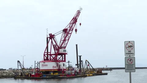 California  A view of a large red crain at the end of the Oceanside Harbor Stock Footage 245463792