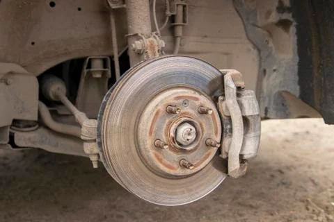 Caliper and brake disc of the front wheel of the car. Stock Photos