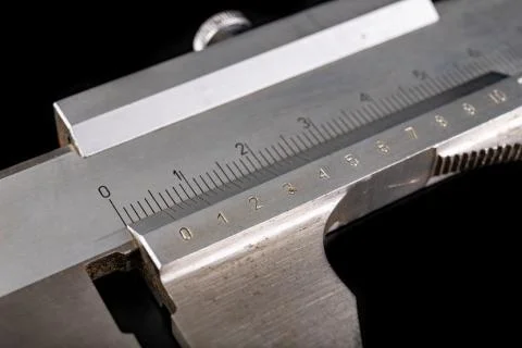 Caliper on a dark workshop table. A tool for precise measurement in the works Stock Photos