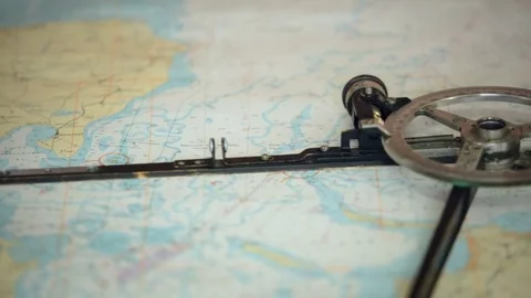 Caliper lies on the old map. Calculate route Stock-Footage 84695314