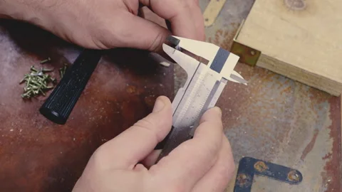Caliper measuring screw head Old tools grungy background Woodworking Vídeo Stock 321601325