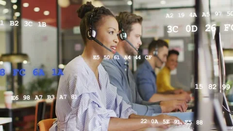 Call agent receiving call, talking on headset and typing, assisting caller, code Stock Footage 333078239