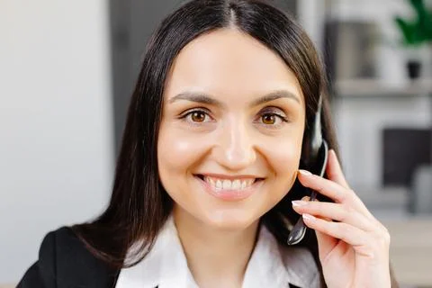 Call center agent with headset working on support hotline in modern office... Stock Photos