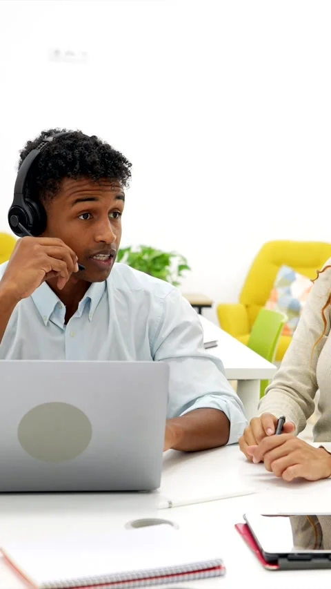Call center agent high fiving coworker in office Stock Footage 318210045