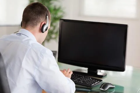 Call center agent looking for a solution in his computer Stock Photos
