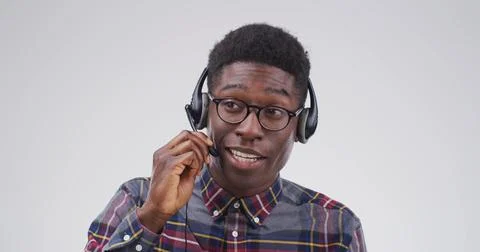 Call center agent, studio and black man listening for tech support, glasses and 写真素材