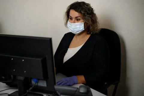 A call center agent working on the support hotline in the office, wearing a m Stock Photos