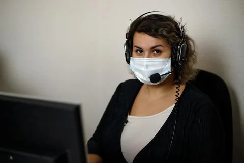 A call center agent working on the support hotline in the office, wearing a m Stock Photos