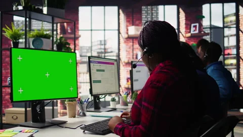 Call center agents tracking shipments in office using green screen computer Stock Footage 305395315